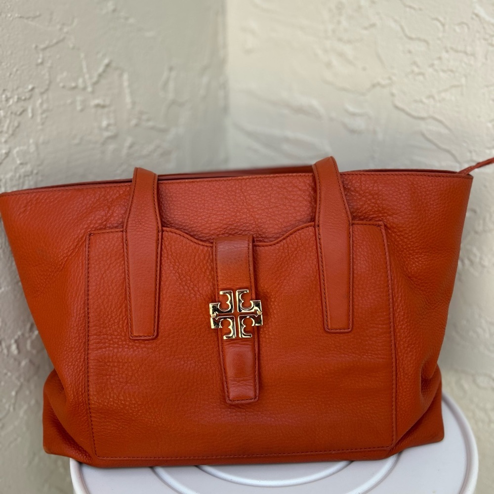 Tory Burch Meyer Plaque Tote in an orange pebbled leather.